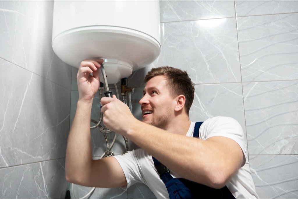 Blue Collars Plumber repairing water heater