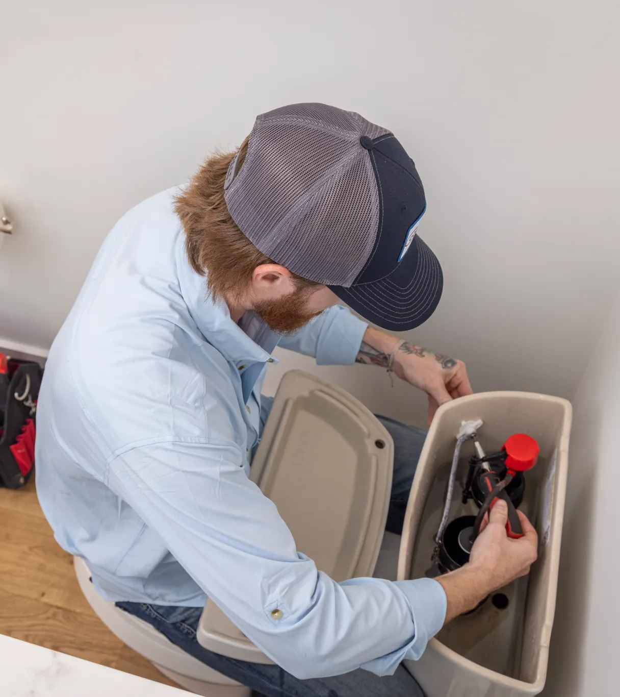 Plumber working on clogged toilet