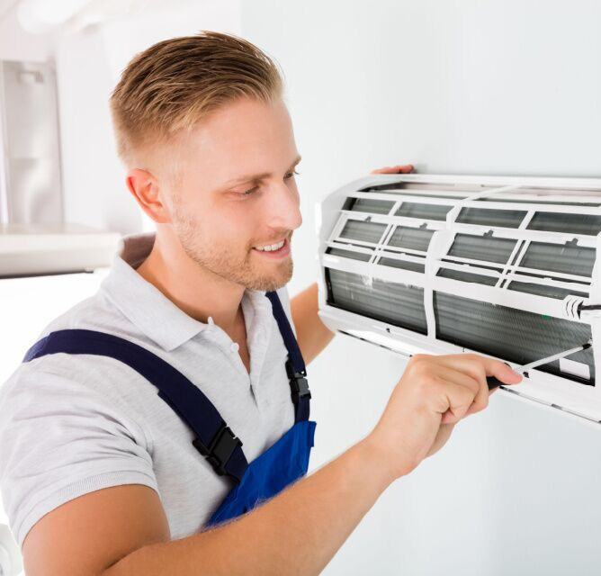 Blue Collars Technician working on AC Unit