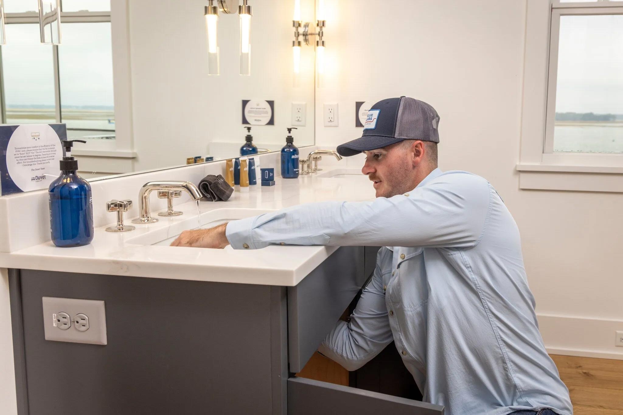 Blue Collars Plumber working on faucet