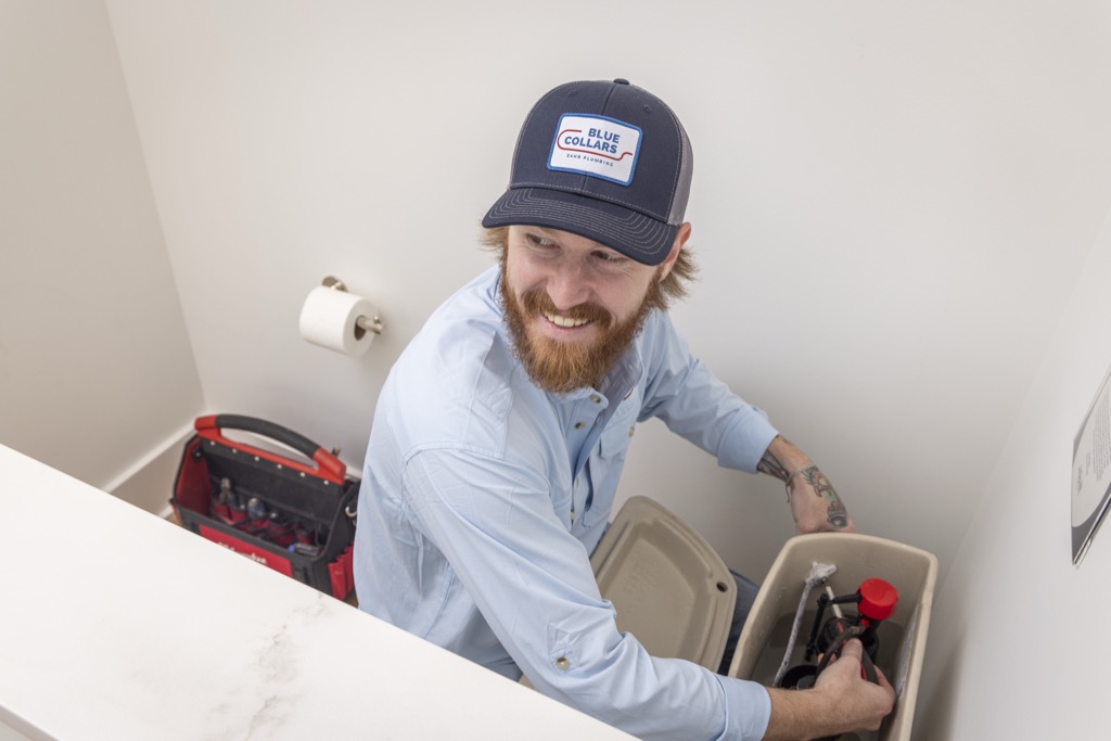 Blue Collars Plumbing Fixing Clogged Toilet