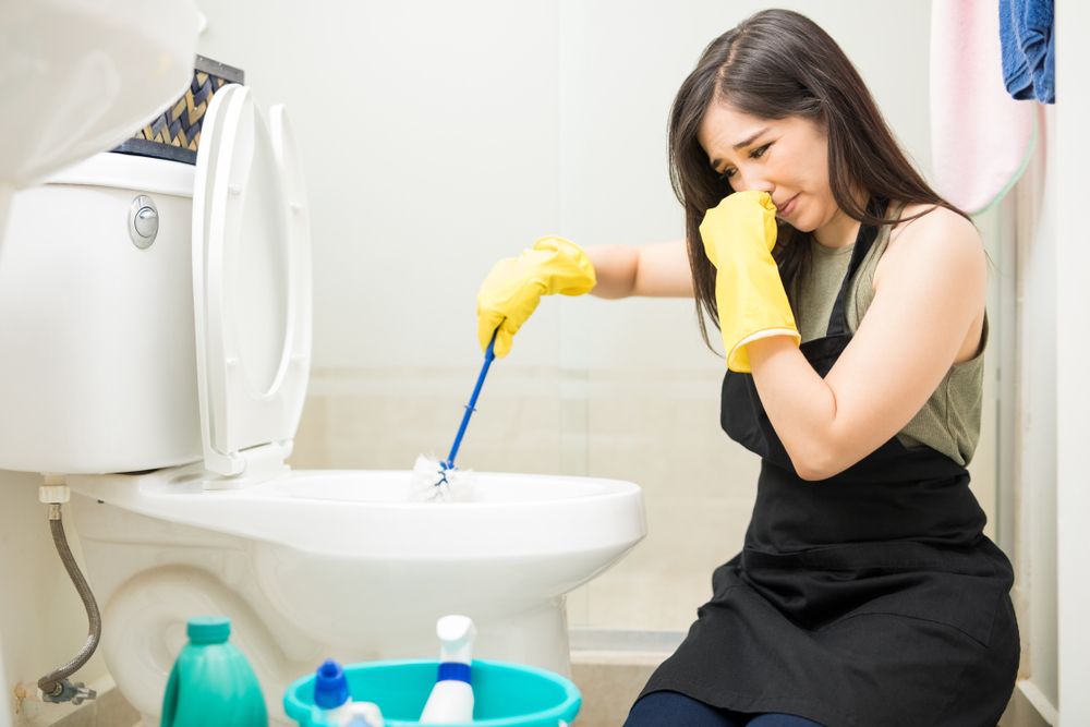 Woman smelling bad water