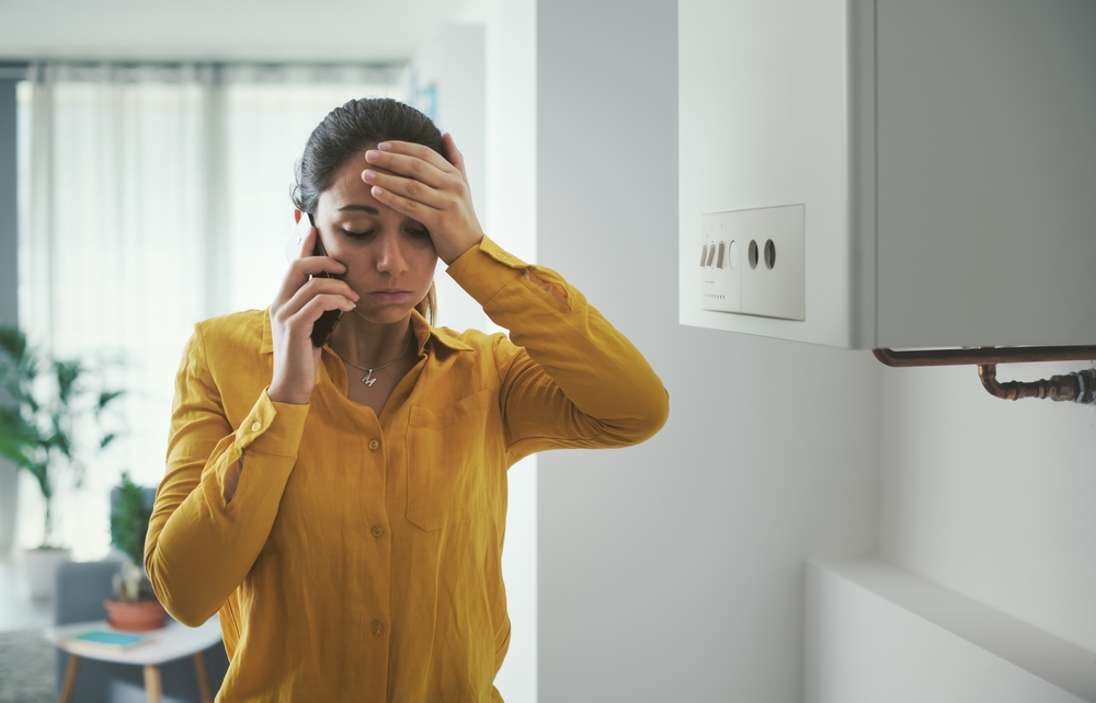 woman calling plumber for plumbing emergency
