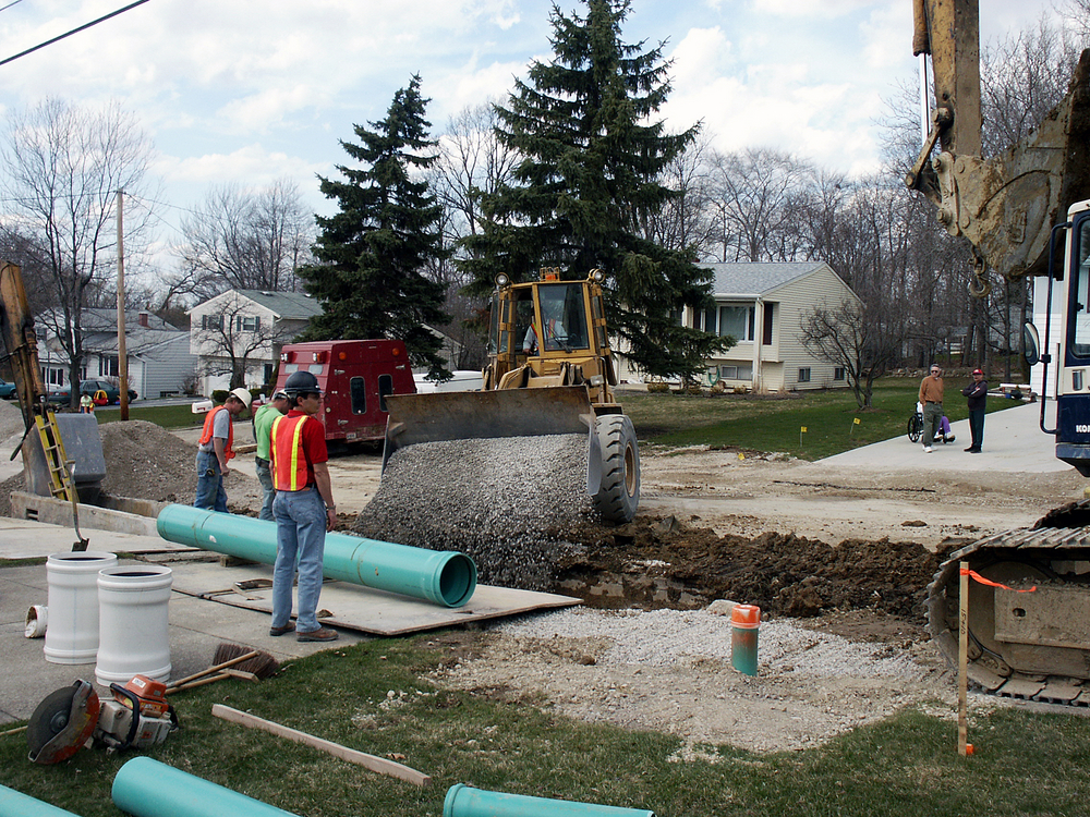 Sewer line replacement with blue collars team.