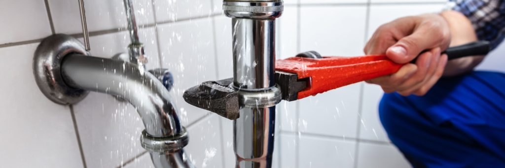 Plumber Fixing Sink Pipes