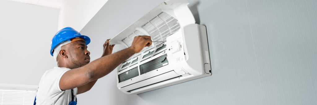 Blue Collars HVAC Technician working on Mini Split