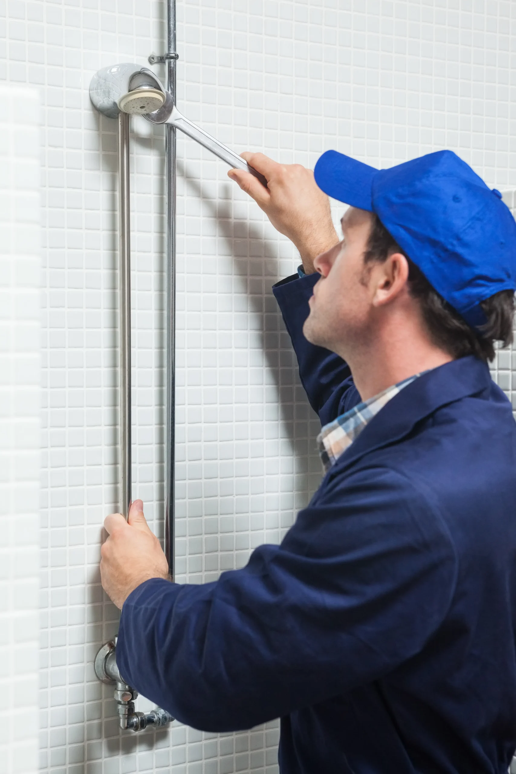serious-plumber-repairing-shower-head